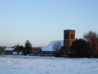 A view of the church at Grimley from across the fields